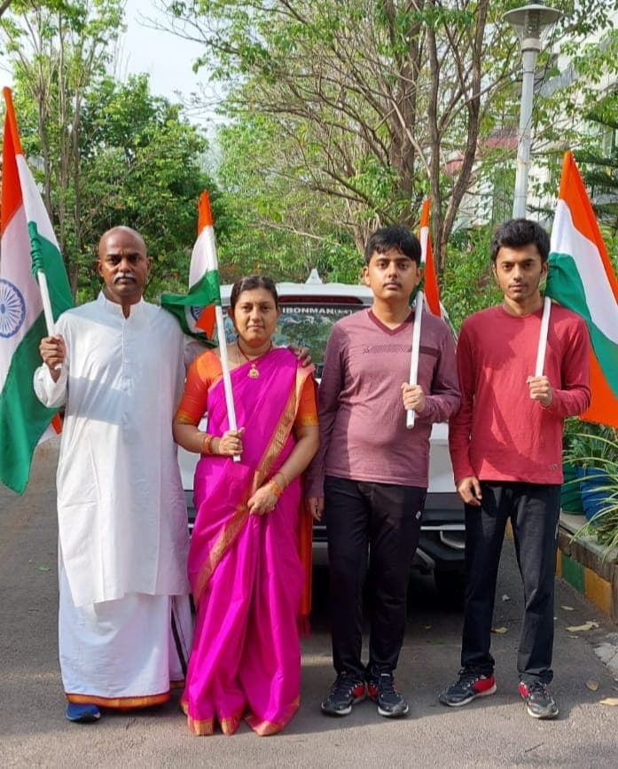Bobba Ravinder Reddy and family holding Indian flags